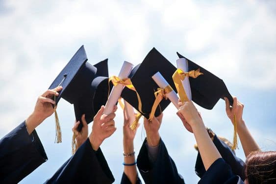 Graduates celebrating with diplomas